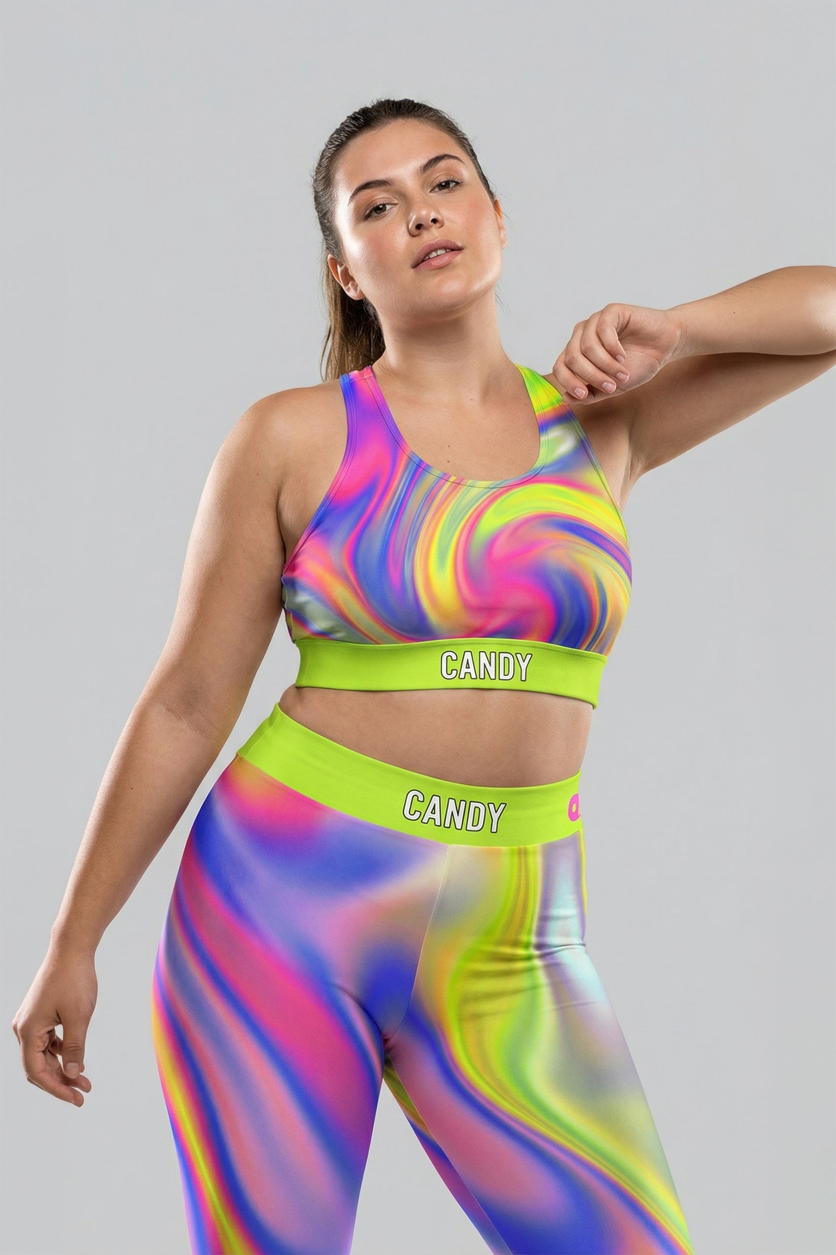 Front view of neon tie-dye sports bra in lime green, pink, and purple, featuring 'CANDY' printed on the bright neon lime waistband.