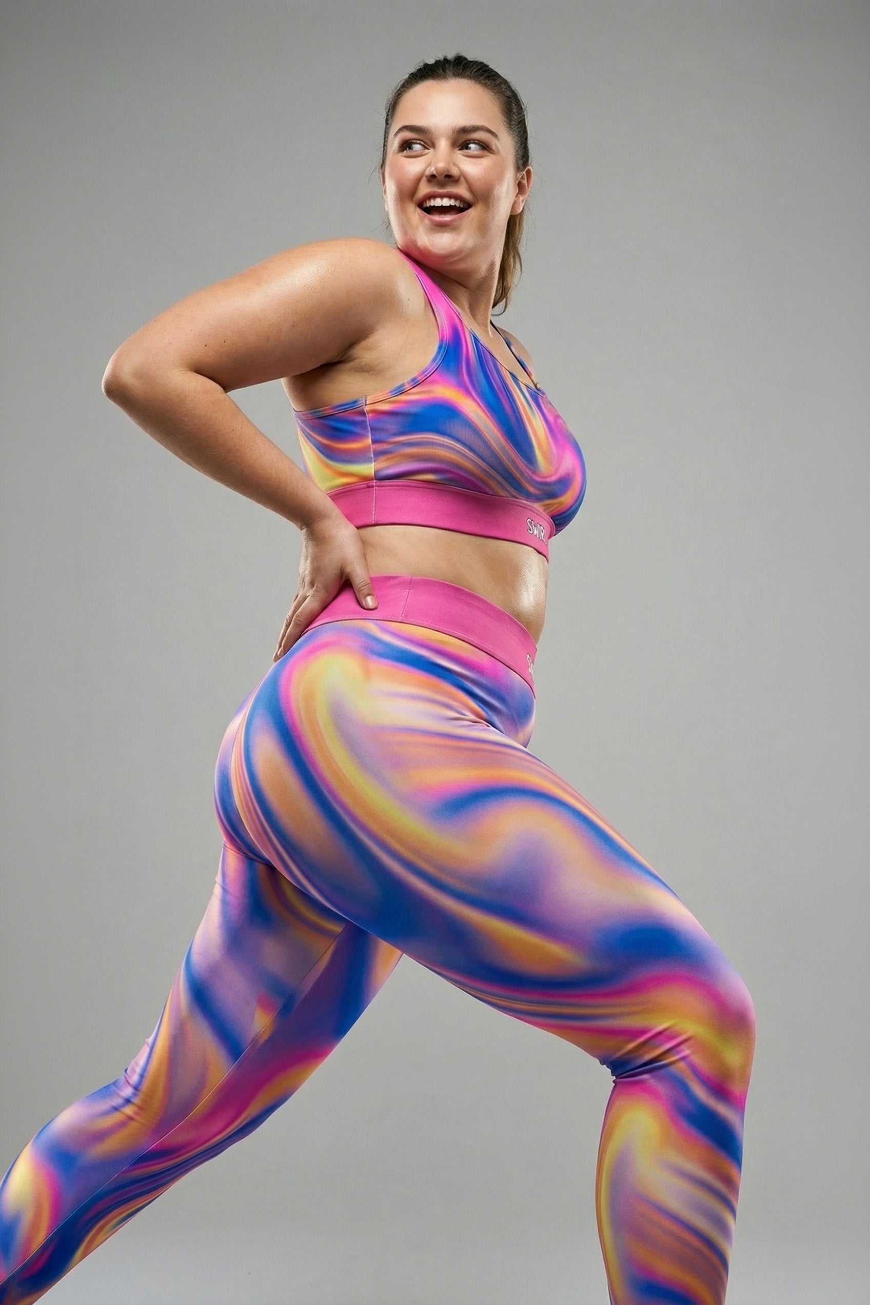 Front view of dark tie-dye sports bra in midnight blue, purple, and black swirls, featuring 'MYSTIC' printed on the solid black waistband.