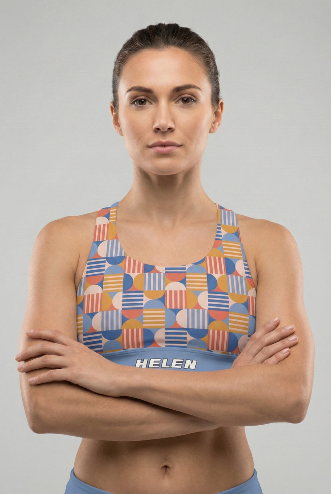 Woman wearing a colorful patterned sports bra with 'OnlyBulked' branding on a gray background
