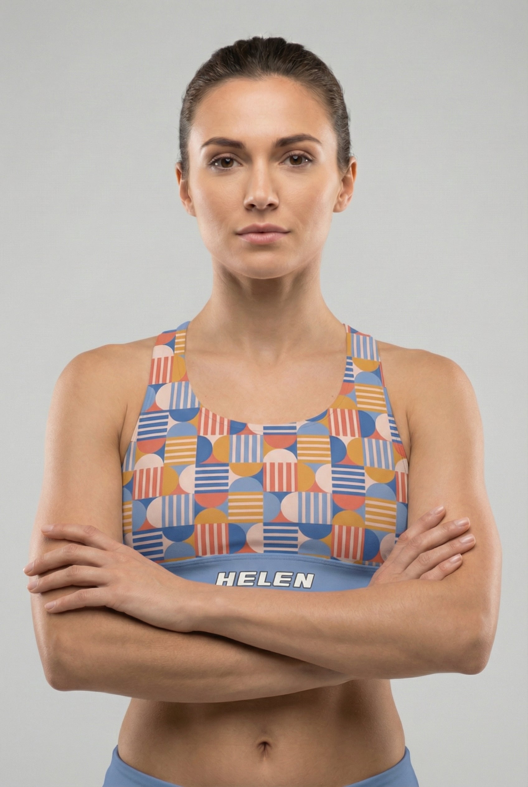 Woman wearing a colorful patterned sports bra with 'OnlyBulked' branding on a gray background
