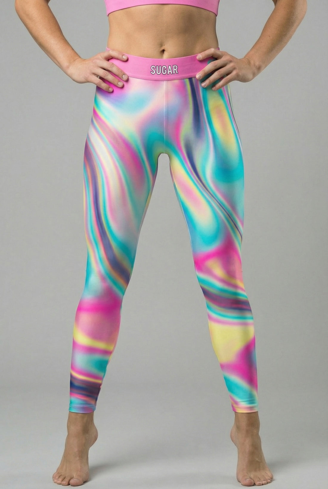 Front view of pastel tie-dye swirl leggings in baby blue, pink, and pale yellow, featuring 'SUGAR' printed on the pink waistband.