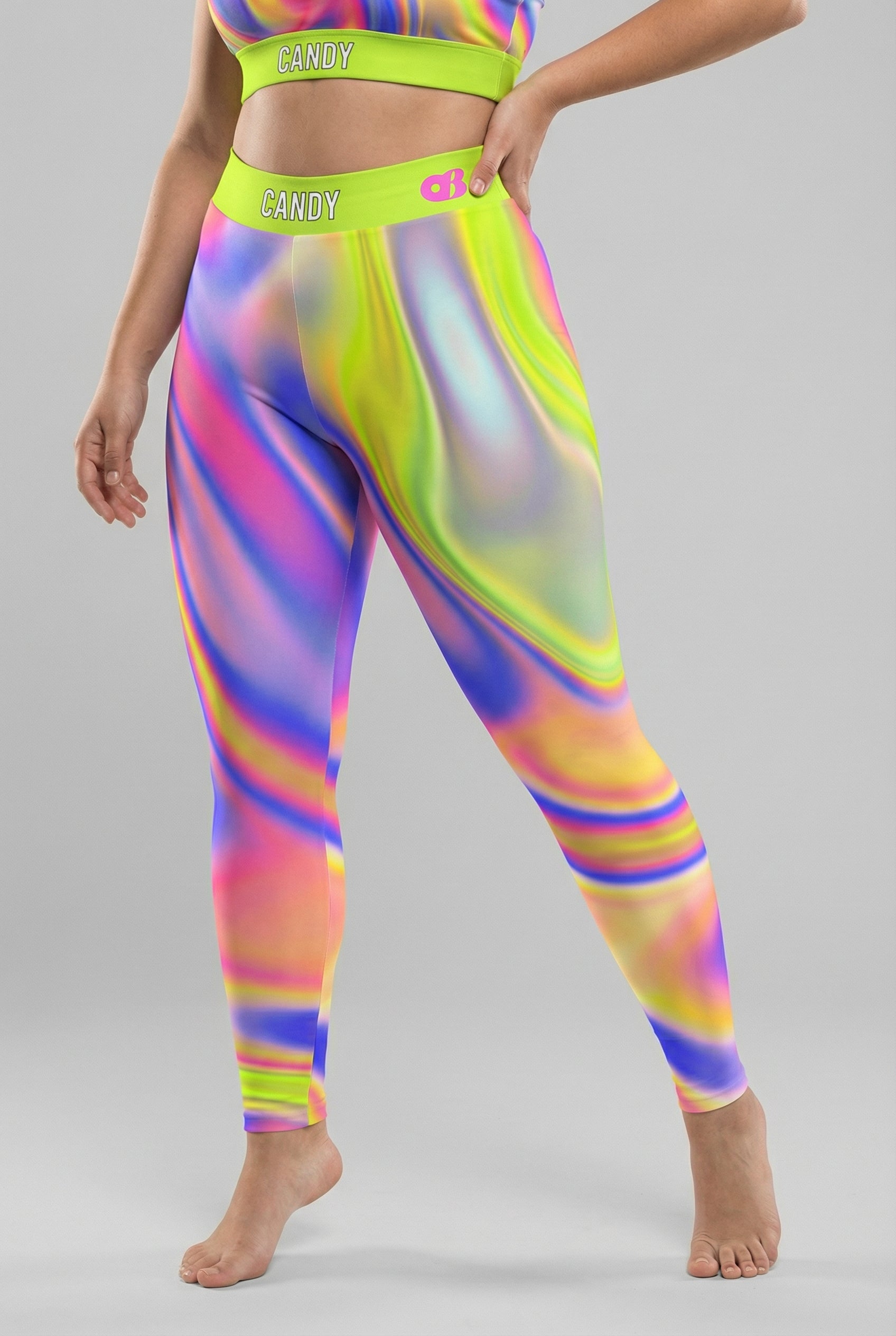 Front view of neon tie-dye swirl leggings in lime green, pink, and purple, featuring 'CANDY' printed on the bright neon lime waistband.