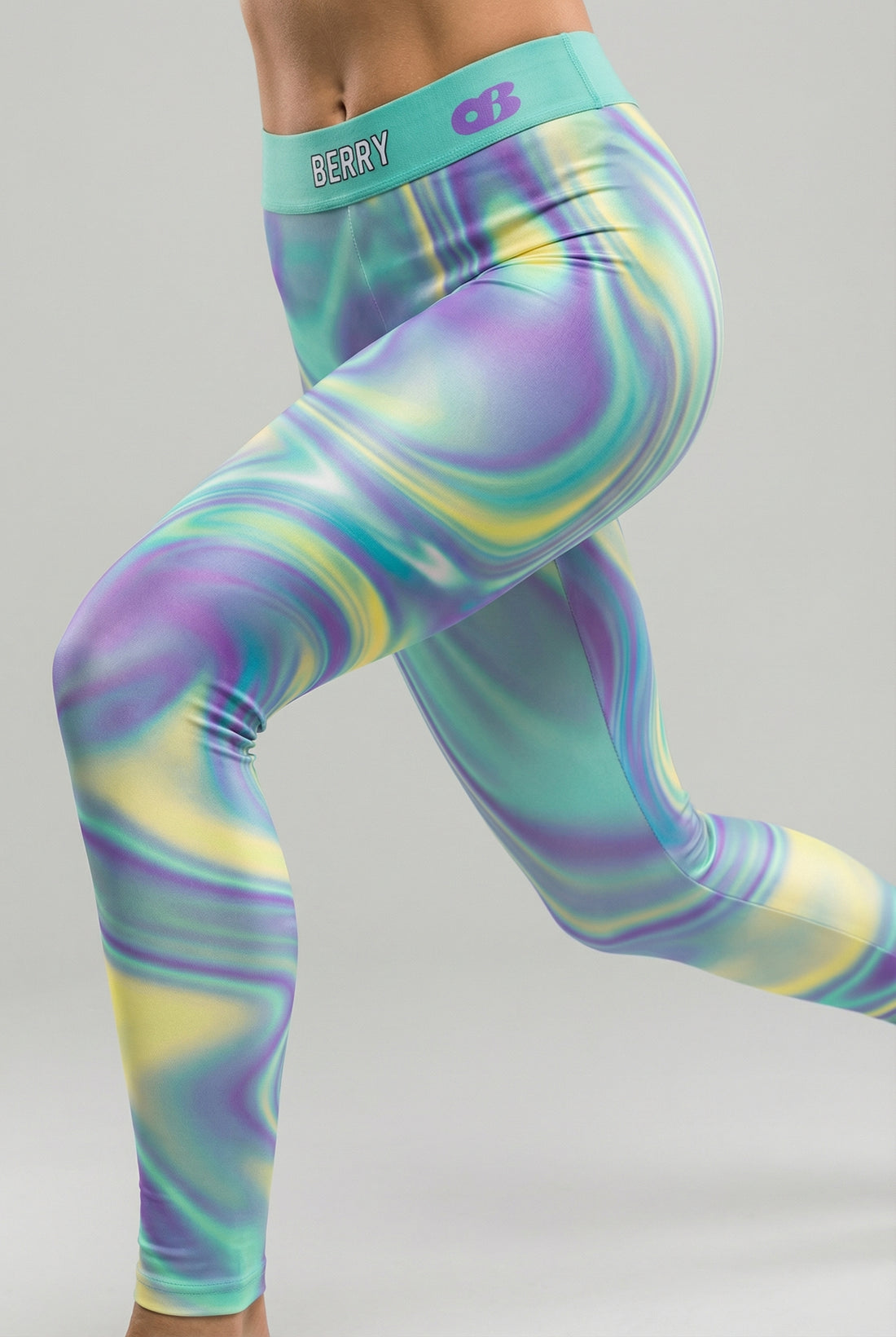 Front view of tie-dye swirl leggings in purple, mint green, and yellow, featuring 'BERRY' printed on the solid mint green waistband.