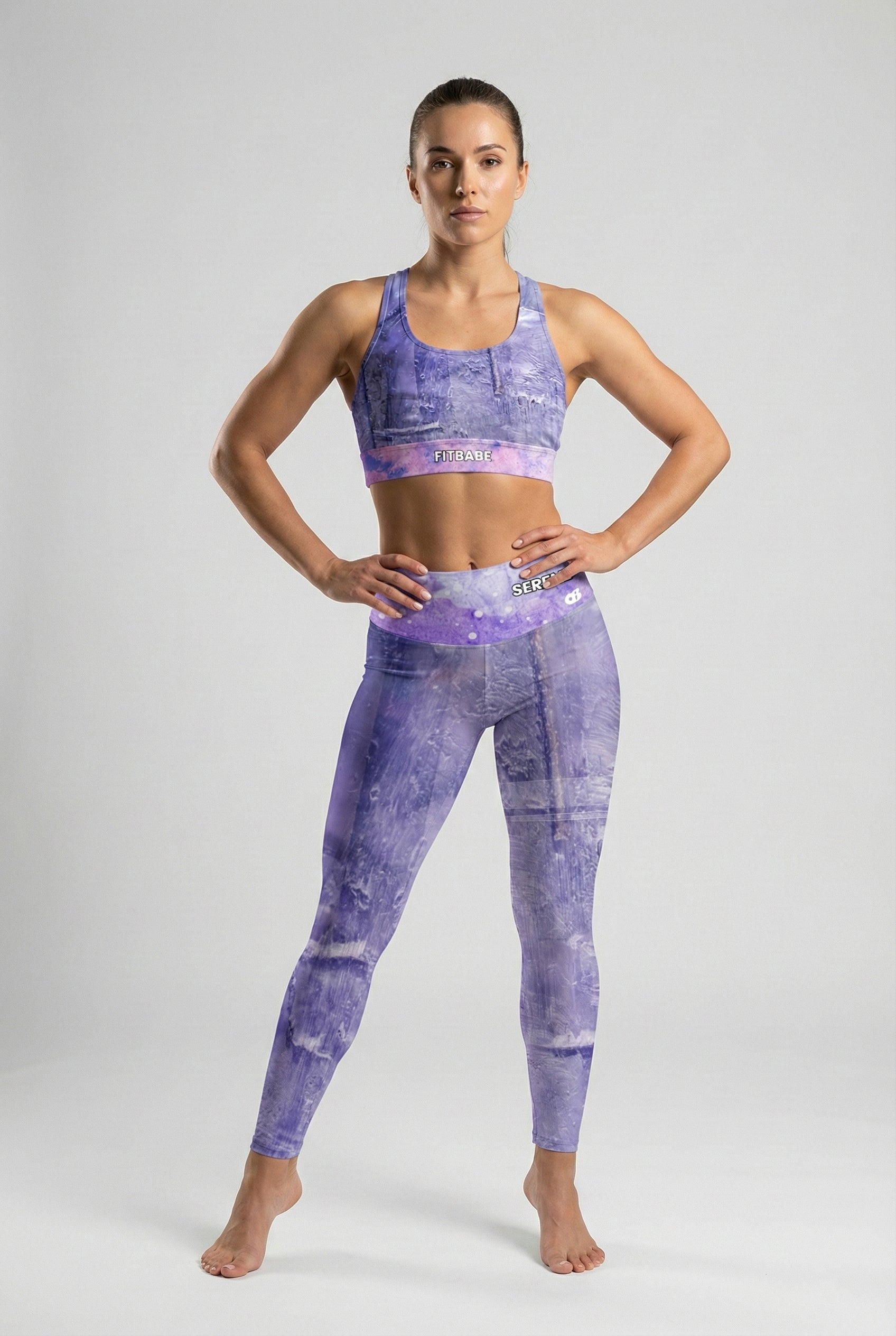 Full body shot of model in Tanzanite Violet leggings with custom text 'SERENITY' on the waistband. OnlyBulked