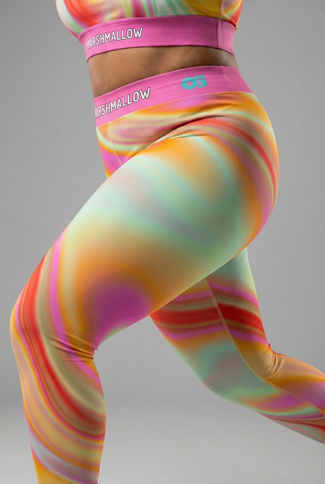 Front view of pastel tie-dye swirl leggings in peach, yellow, mint, and pink, featuring 'MARSHMALLOW' printed on the bubblegum pink waistband.