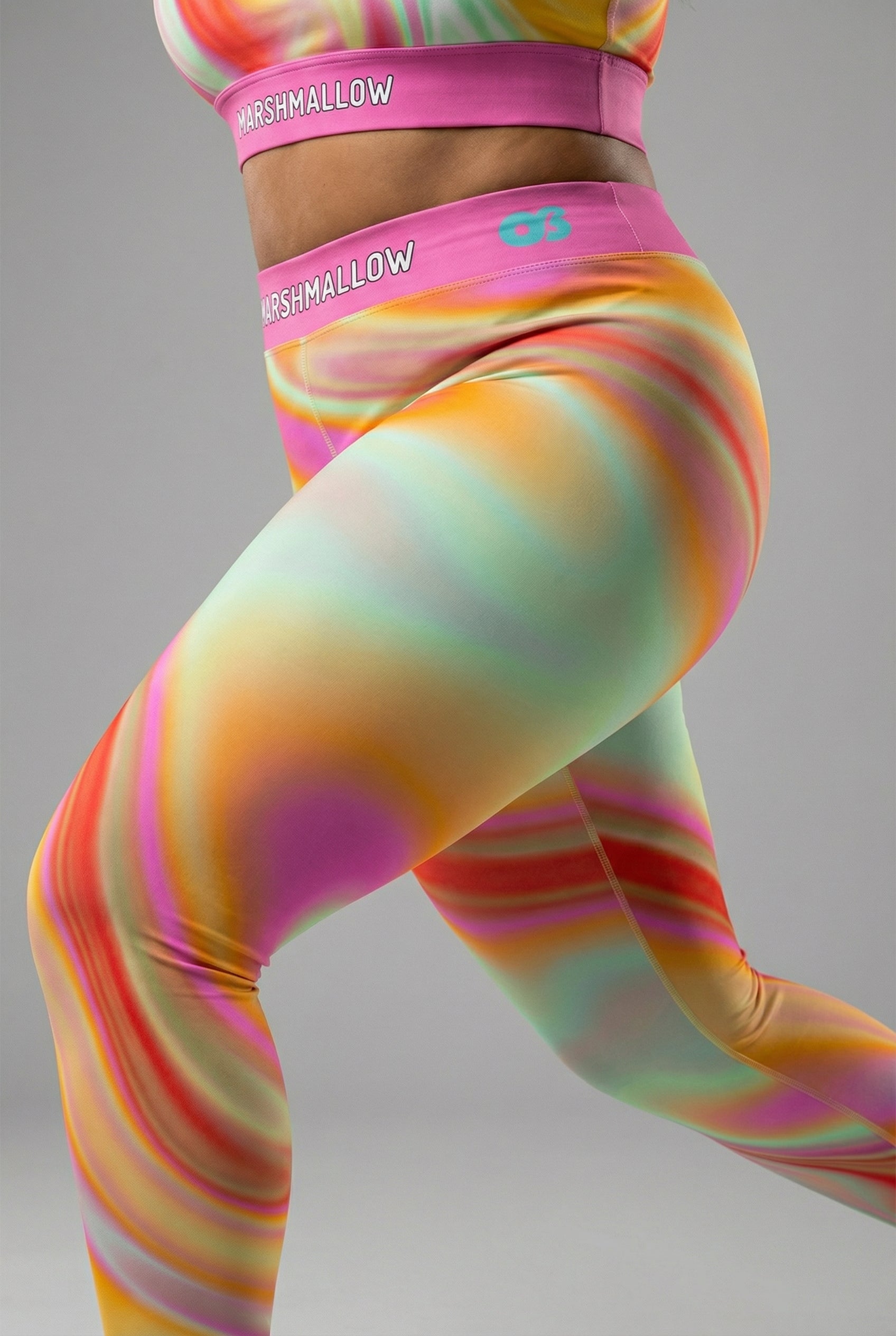 Front view of pastel tie-dye swirl leggings in peach, yellow, mint, and pink, featuring 'MARSHMALLOW' printed on the bubblegum pink waistband.