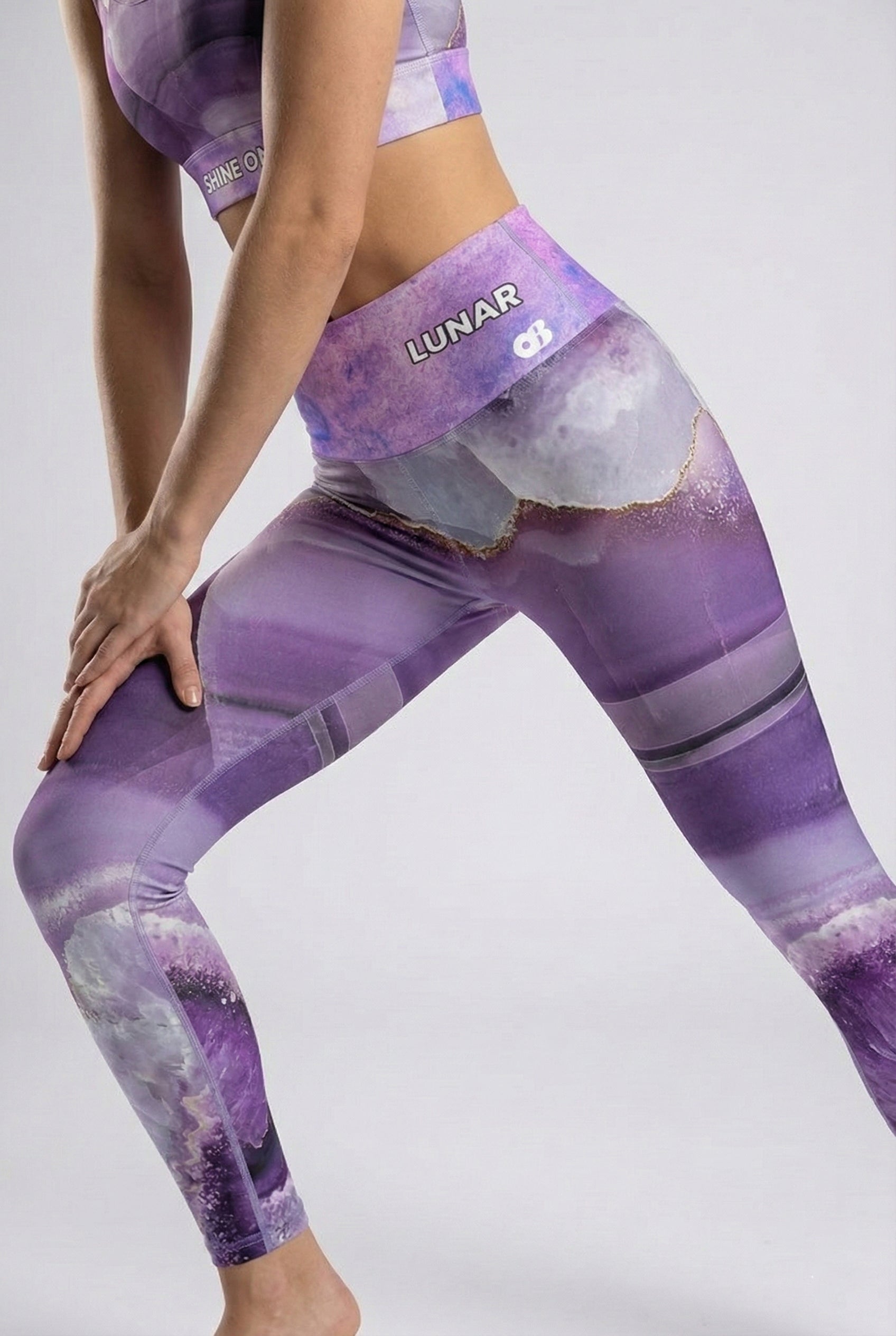 Person wearing purple and white leggings with 'OnlyBulked' branding on a light gray background. 