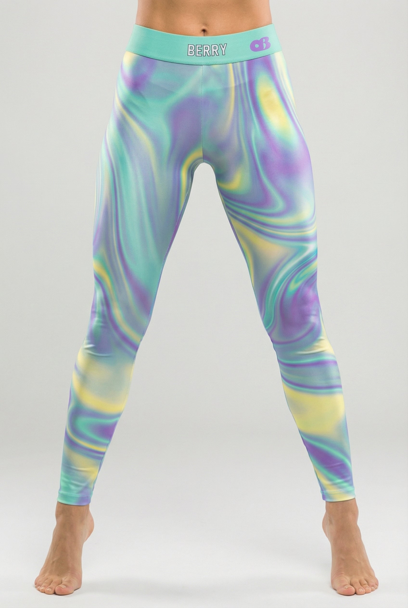 Front view of tie-dye swirl leggings in purple, mint green, and yellow, featuring 'BERRY' printed on the solid mint green waistband.