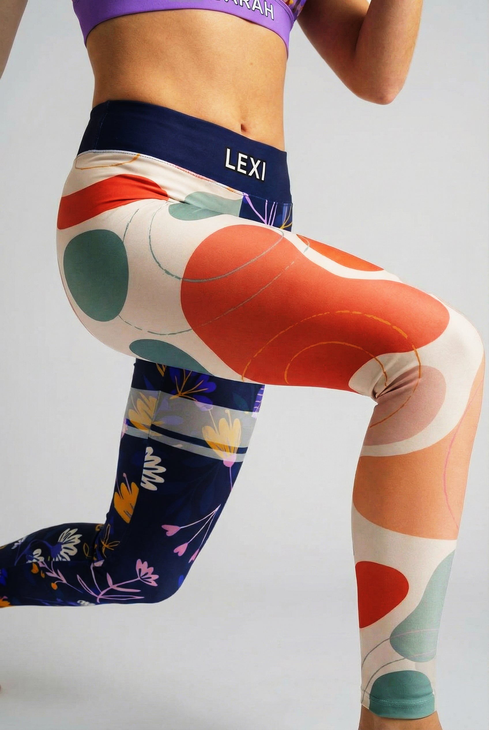 Close up of terracotta and sage green abstract blobs contrasting with dark blue wildflower print.