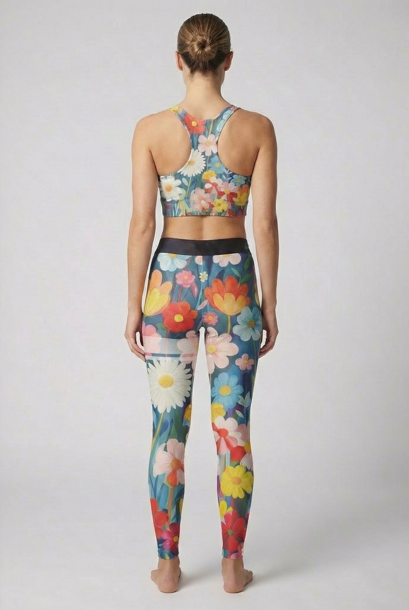 Colorful hand-painted flower pattern on teal background activewear.