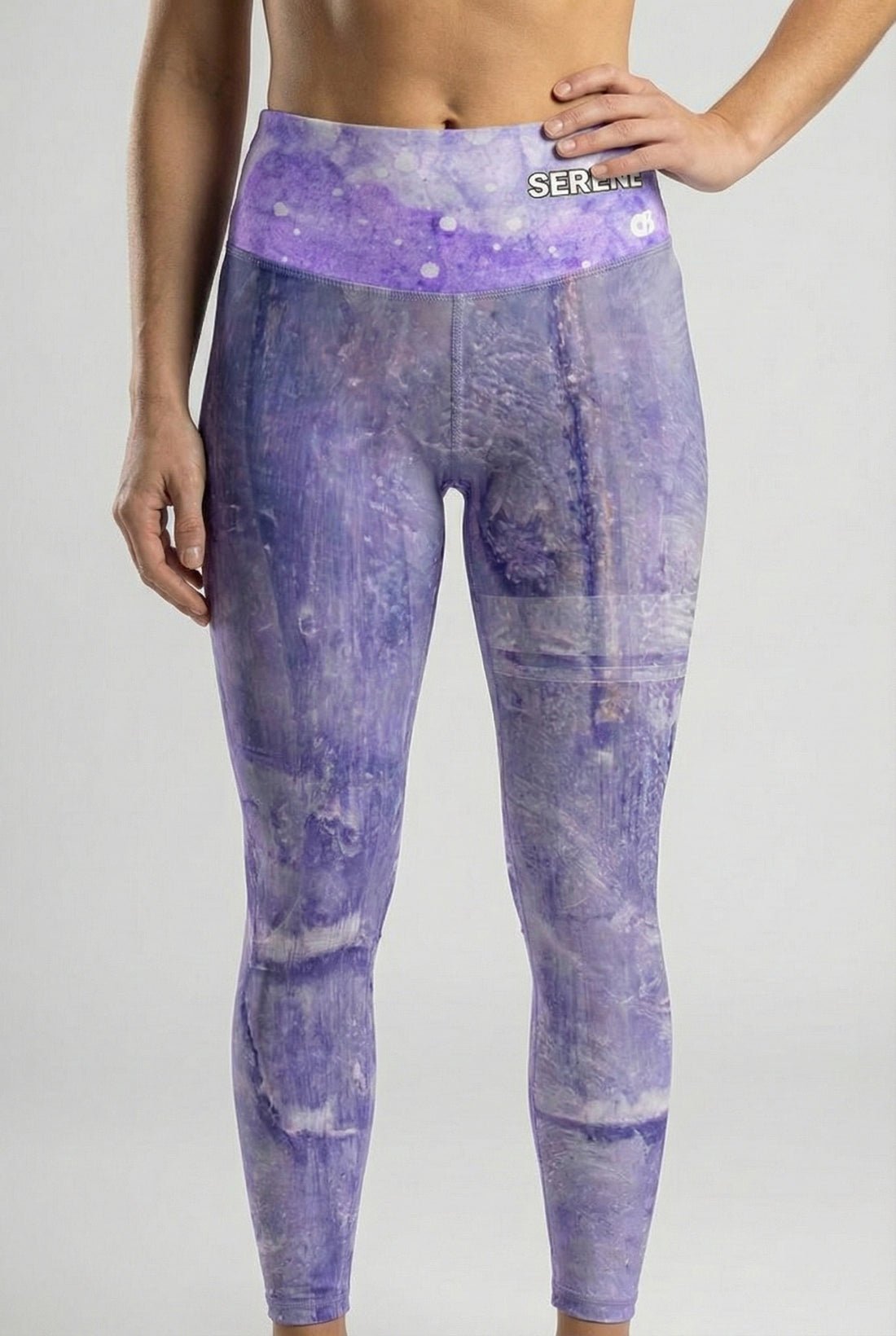 Purple tie-dye leggings with a visible brand logo on a gray background