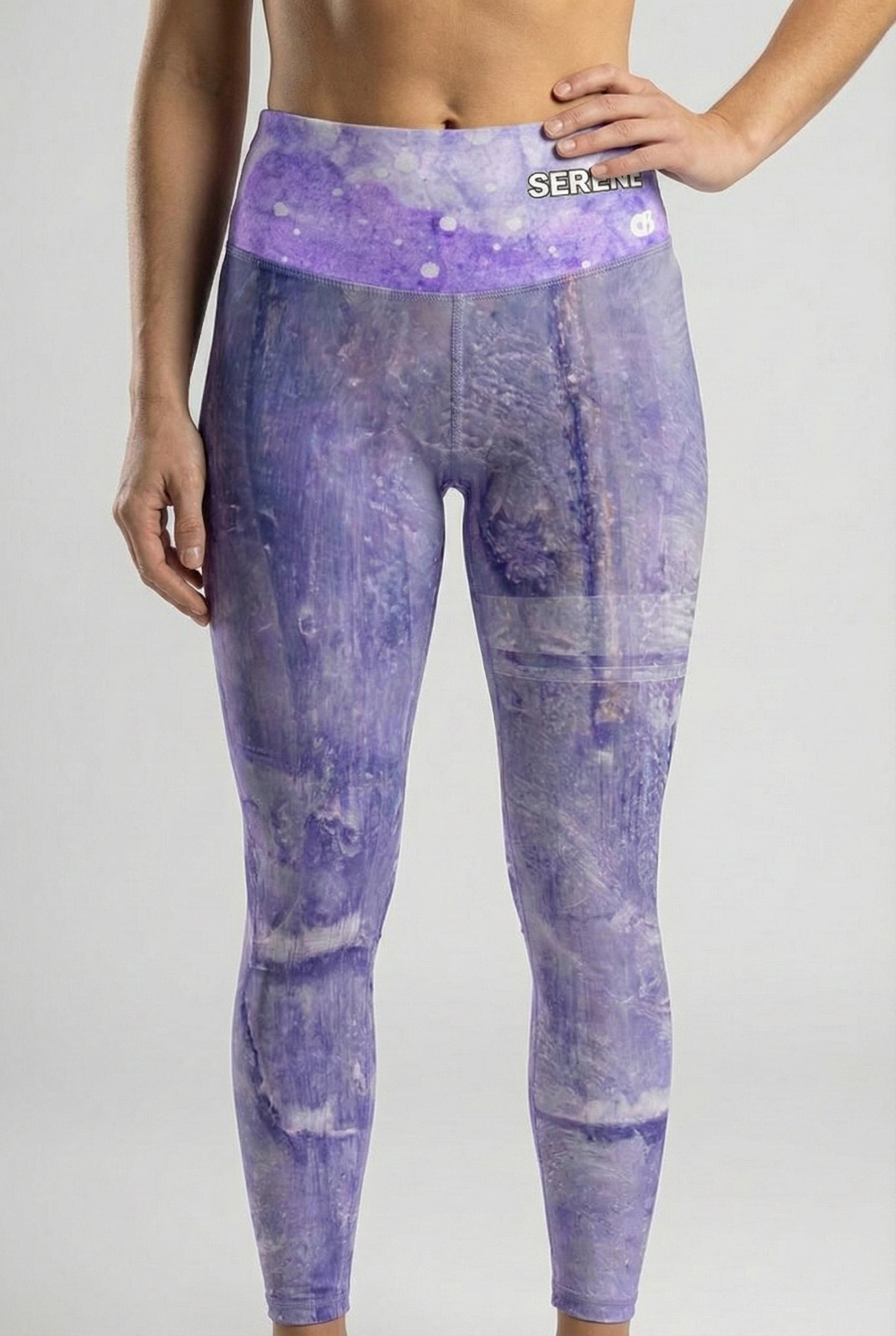 Purple tie-dye leggings with a visible brand logo on a gray background
