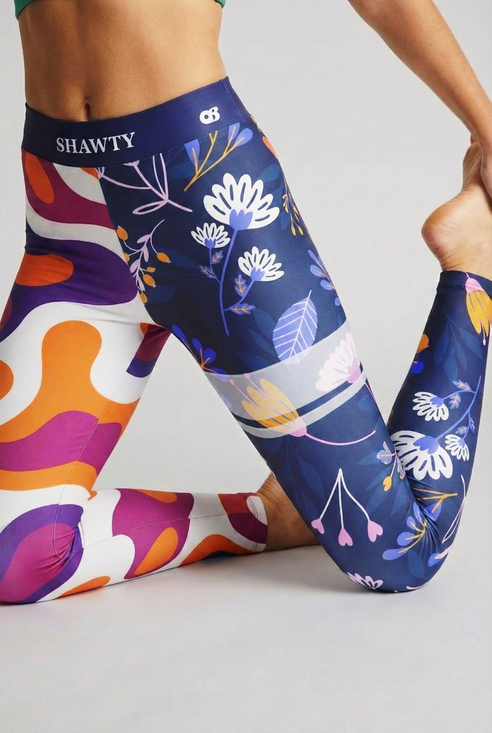 lose up of mismatch patterns: psychedelic abstract waves vs botanical flowers on activewear.