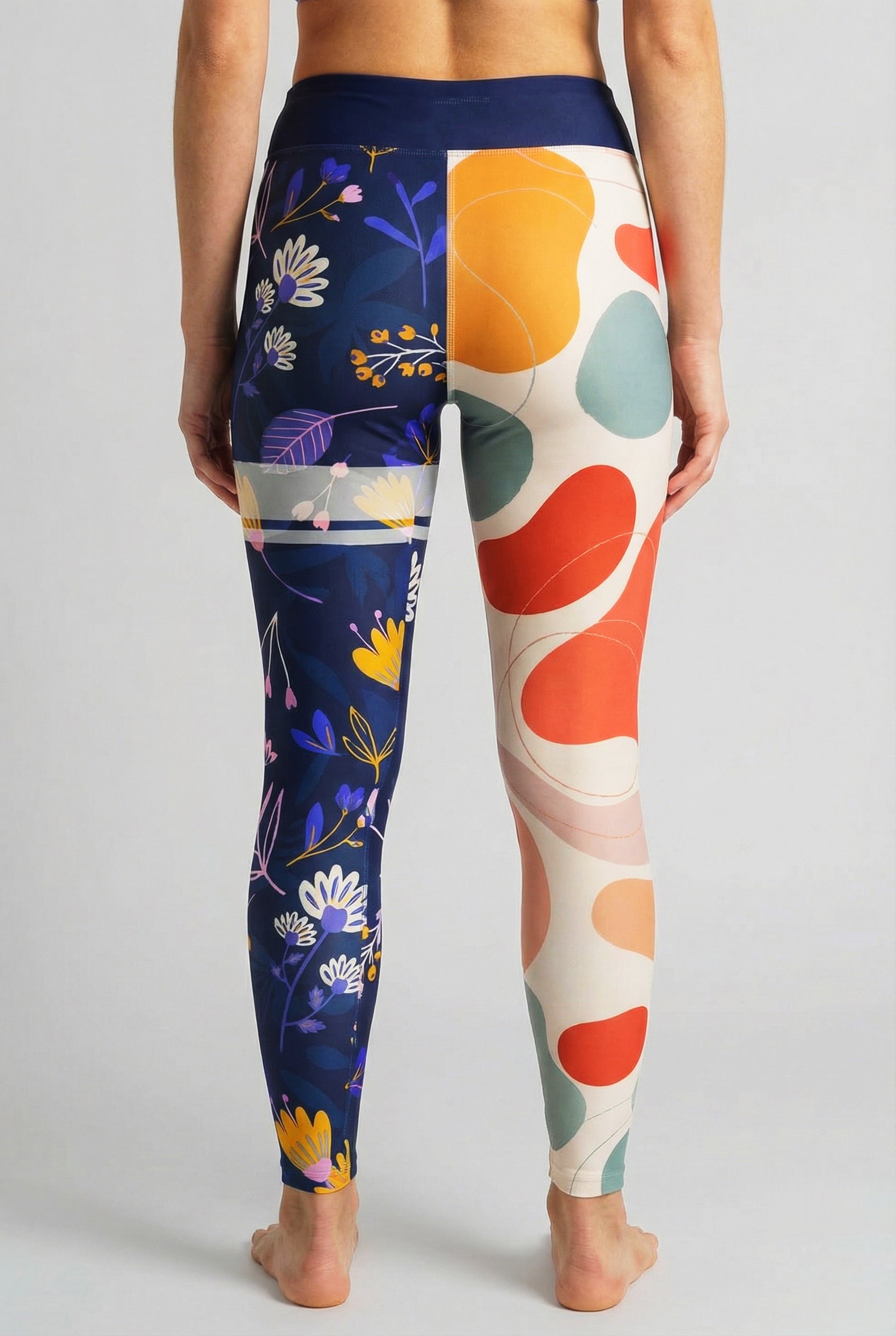 Split-leg leggings with beige abstract shapes on left leg and navy floral print on right leg, custom text 'LEXI' on waistband.