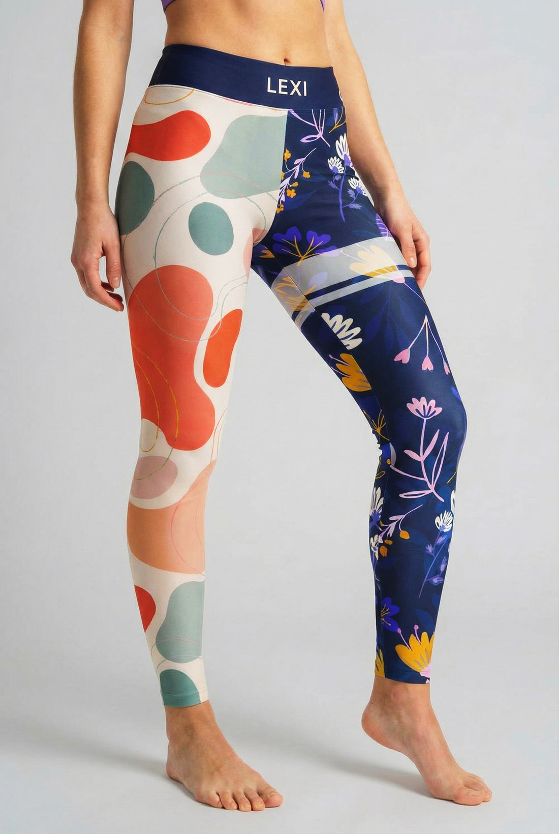 Split-leg leggings with beige abstract shapes on left leg and navy floral print on right leg, custom text 'LEXI' on waistband.