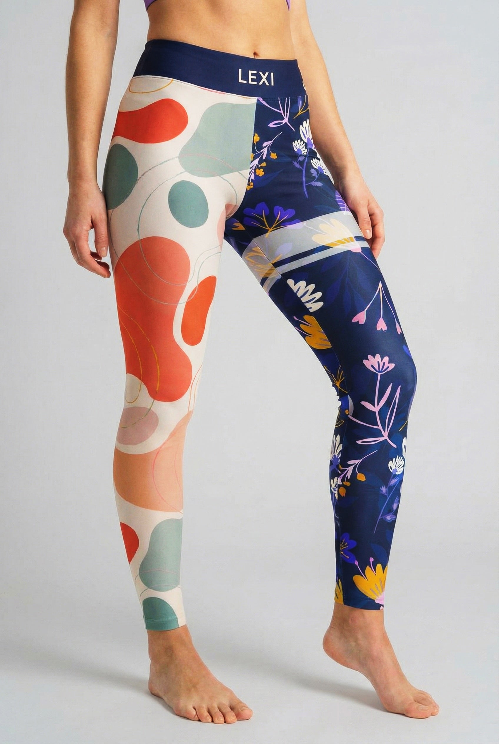 Split-leg leggings with beige abstract shapes on left leg and navy floral print on right leg, custom text 'LEXI' on waistband.