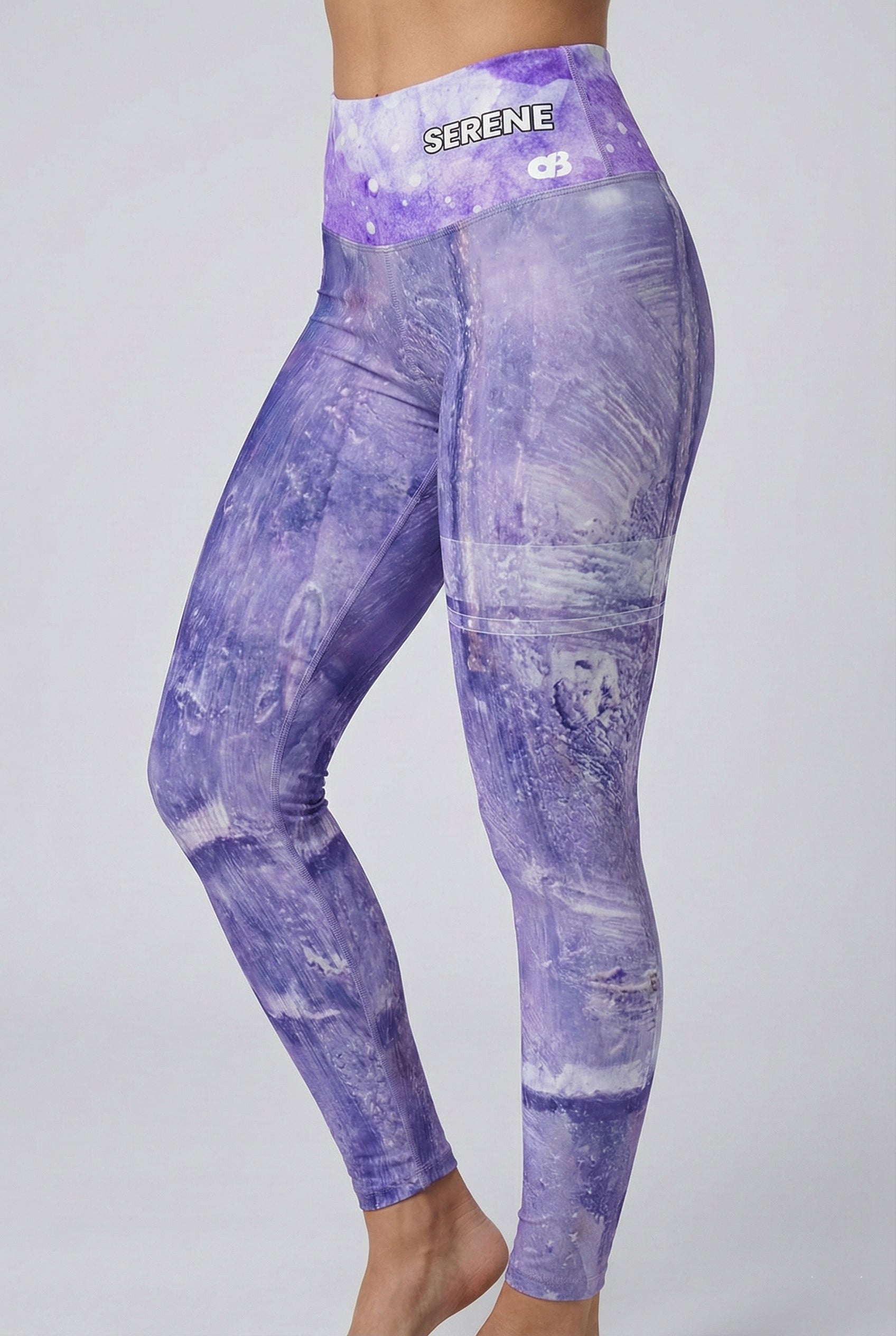 Purple tie-dye leggings with 'SERENE' branding on a gray background